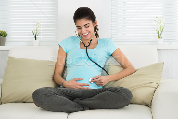 Portrait Of Pregnant Woman Listening To Baby Heartbeat Stock photo © AndreyPopov