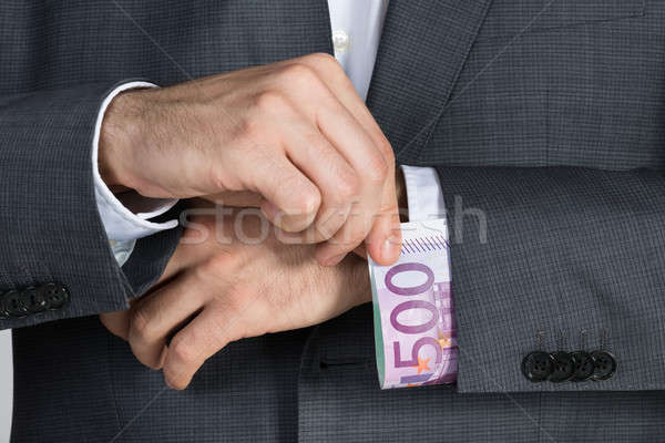 üzletember öltöny kabátujj iroda pénz férfi Stock fotó © AndreyPopov