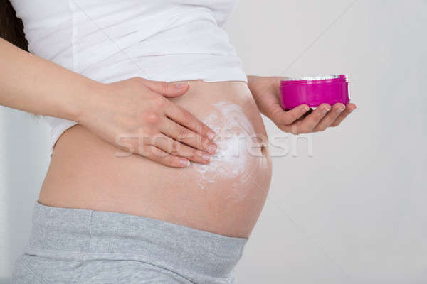 Pregnant Woman Applying Cream On Her Belly Stock photo © AndreyPopov