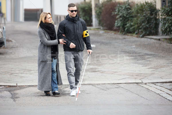 Woman Assisting Blind Man On Street Stock photo © AndreyPopov