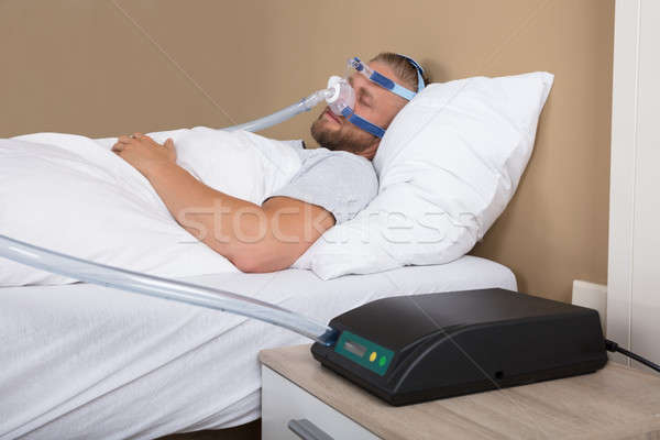 Man With Sleeping Apnea And CPAP Machine Stock photo © AndreyPopov