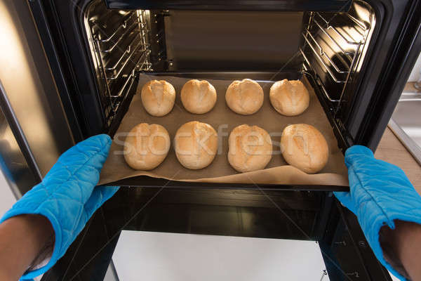 Person Holding Tray Of Baked Bread Stock photo © AndreyPopov