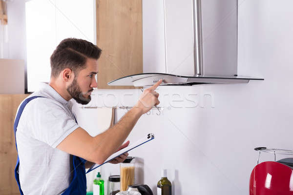 Electrician Repairing Kitchen Extractor Filter Stock photo © AndreyPopov