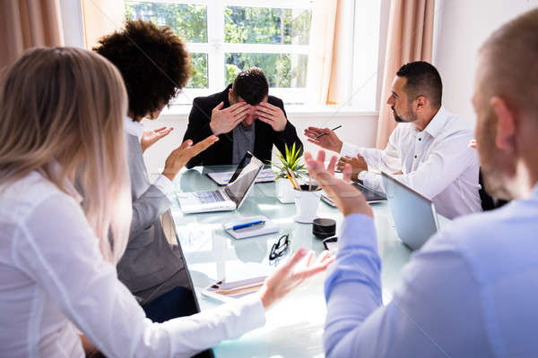 Businesspeople Blaming Their Colleague In Office Stock photo © AndreyPopov