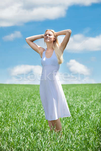 Happy Young Woman In Grassland Stock photo © AndreyPopov