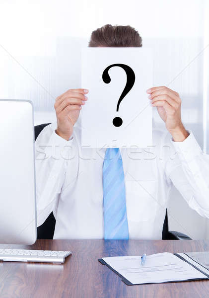 Businessman Holding Question Mark Sign On Paper Stock photo © AndreyPopov