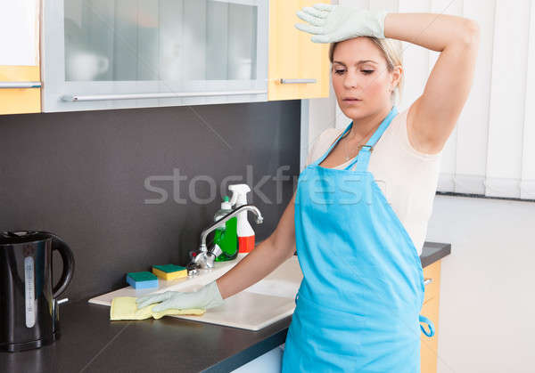 Woman Tired Cleaning Kitchen Worktop At Home Stock photo © AndreyPopov