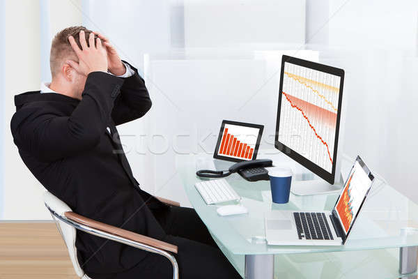 Despairing businessman faced with financial losses Stock photo © AndreyPopov