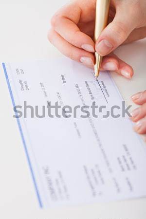 Zakenvrouw ondertekening cheque afbeelding bureau vrouw Stockfoto © AndreyPopov