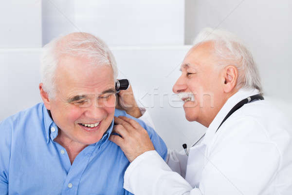 Doctor Examining Senior Man's Ear With Otoscope Stock photo © AndreyPopov