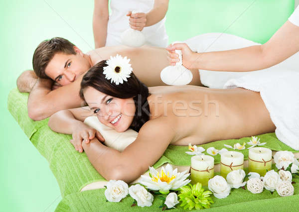 Couple Receiving Massage With Herbal Compress Balls Stock photo © AndreyPopov