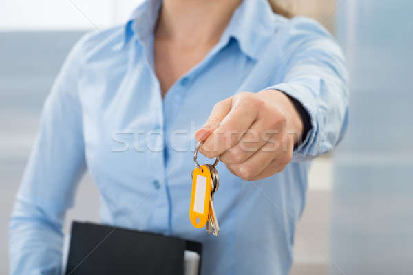 Businesswoman With Key And Folder Stock photo © AndreyPopov