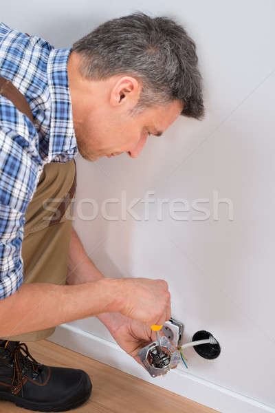 Male Technician Fixing Socket Stock photo © AndreyPopov