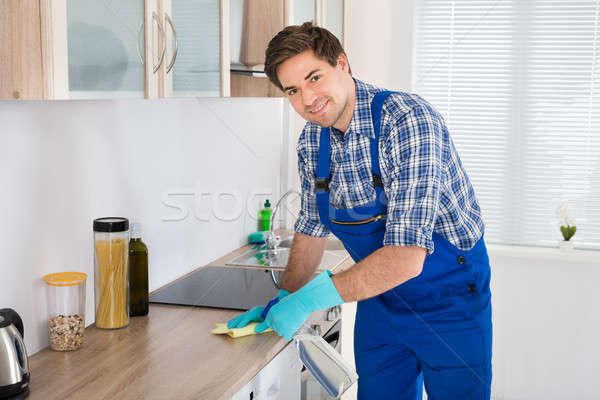 Munkás takarítás rongy fiatal átfogó konyha Stock fotó © AndreyPopov