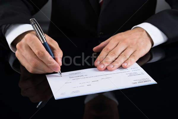 Ondertekening cheque handen pen Stockfoto © AndreyPopov