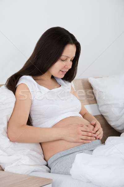Expecting Woman Sitting On Bed Stock photo © AndreyPopov