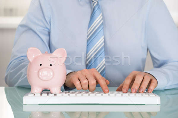 Stock photo: Businessman With Piggyback And Keyboard