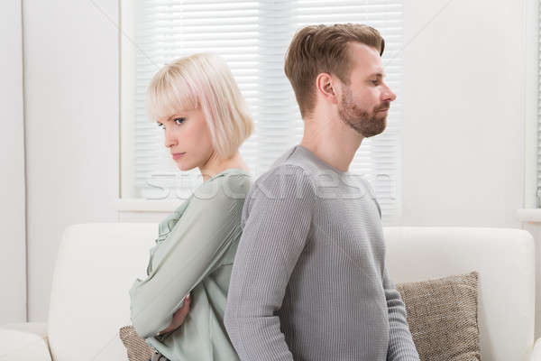 Couple Sitting Back To Back On Couch Stock photo © AndreyPopov