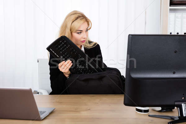 Businesswoman Stealing A Keyboard Stock photo © AndreyPopov