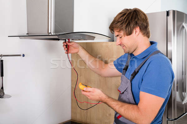 Repairman Checking Kitchen Extractor Filter Stock photo © AndreyPopov