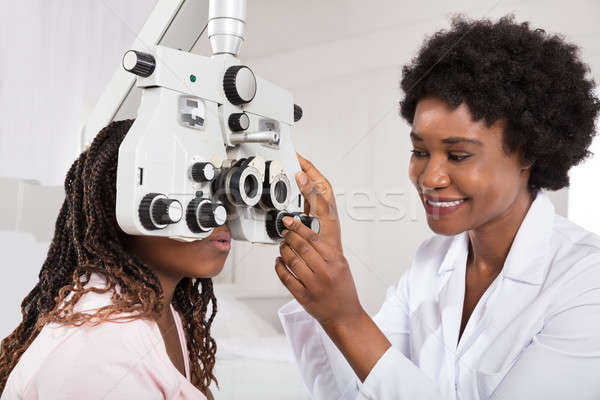 Optometrist Doing Sight Testing For Patient Stock photo © AndreyPopov