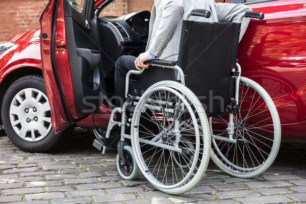 Man Sitting In Car Folding His Wheelchair Stock photo © AndreyPopov