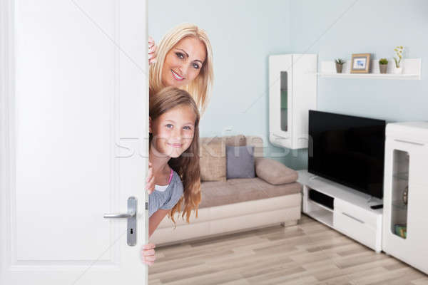 Stock photo: Mother And Daughter Peeking From Door