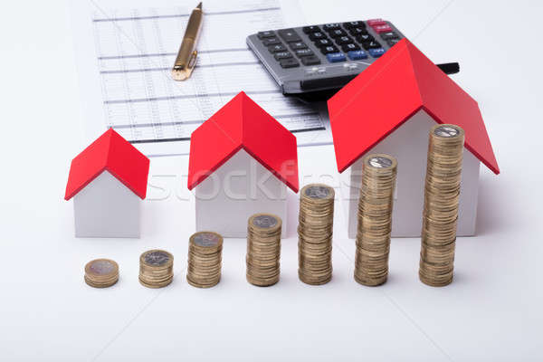 Stack Of Coins In Front Of House Model And Documents Stock photo © AndreyPopov