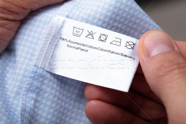Man Holding Cloth Label Showing Washing Instructions Stock photo © AndreyPopov