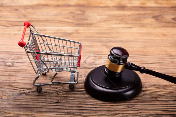 Judge Gavel And Shopping Cart On Table Stock photo © AndreyPopov