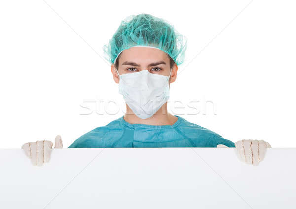 Surgeon holding up a blank banner Stock photo © AndreyPopov