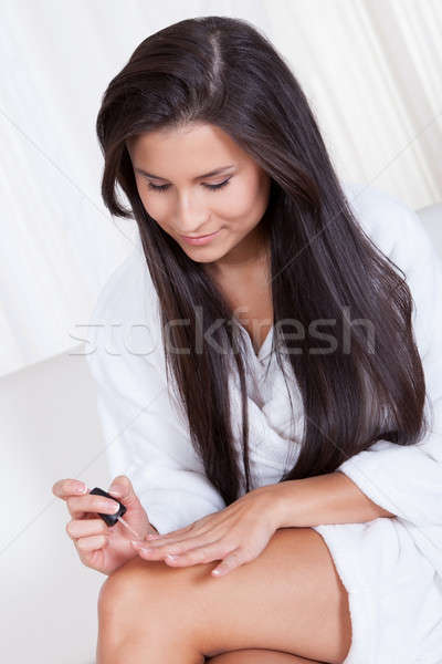 Woman sitting painting her nails Stock photo © AndreyPopov