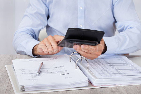 Businessman Calculating Financial Expenses Stock photo © AndreyPopov