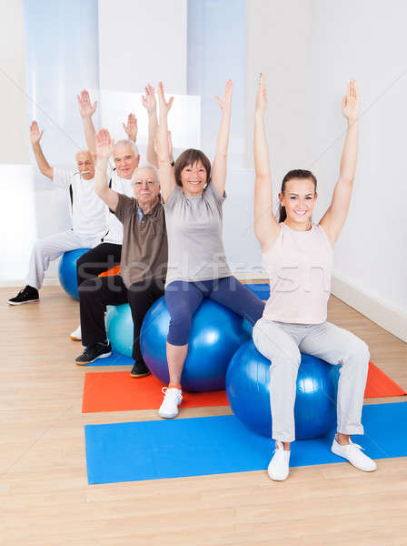 Trainer And Senior Customers Stretching On Fitness Balls Stock photo © AndreyPopov