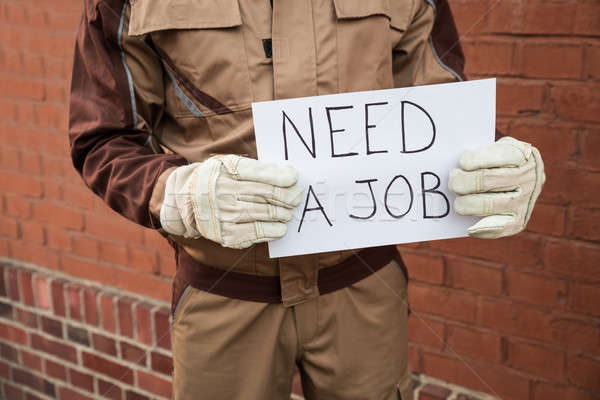 Worker Holding Placard With The Text Need A Job Stock photo © AndreyPopov