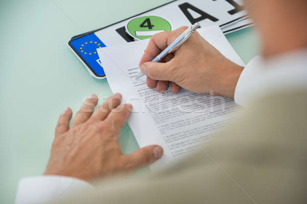 Stock photo: Businessman Filling Car Sale Contract Form