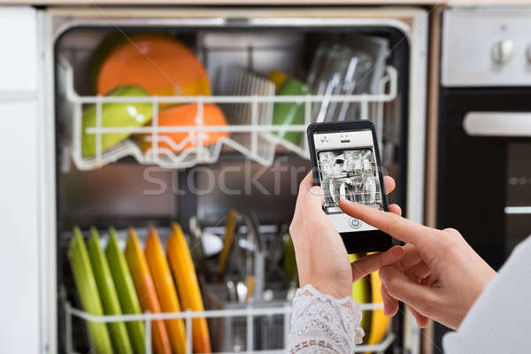 Person Hands Operating Dishwasher Stock photo © AndreyPopov
