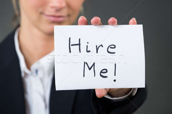 Midsection Of Businesswoman Showing Hire Me Card Stock photo © AndreyPopov