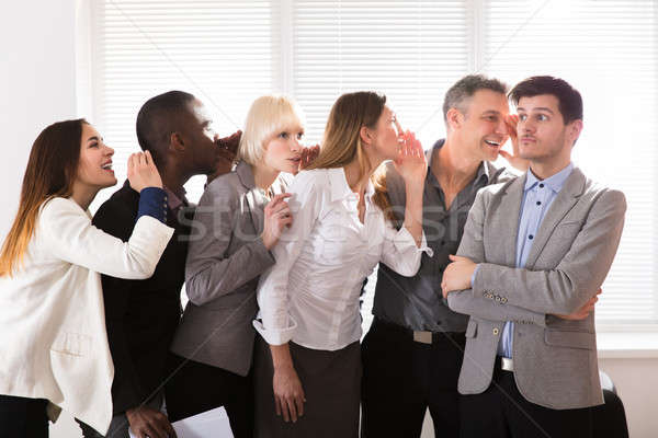 Secretive Business Colleagues Whispering In The Office Stock photo © AndreyPopov