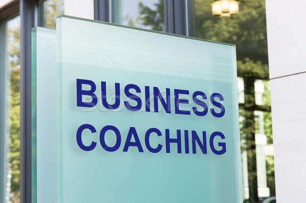 Business coaching sign on glass board outside building in city Stock photo © AndreyPopov