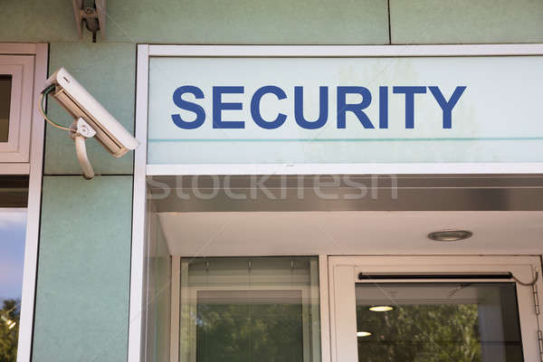 Security camera and sign at entrance Stock photo © AndreyPopov