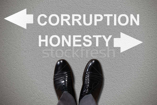 Foot With Arrow Sign Showing Corruption And Honesty Stock photo © AndreyPopov