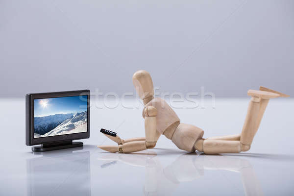 Side View Of A Wooden Dummy Watching Television Stock photo © AndreyPopov