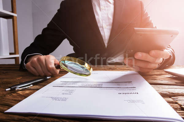 Businessperson Analyzing Bill With Magnifying Glass Stock photo © AndreyPopov
