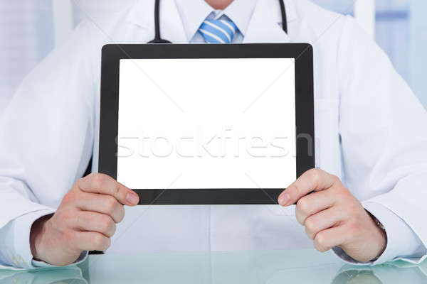 Doctor Displaying Digital Tablet At Desk Stock photo © AndreyPopov