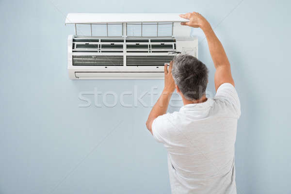 Man Cleaning Air Conditioning System Stock photo © AndreyPopov