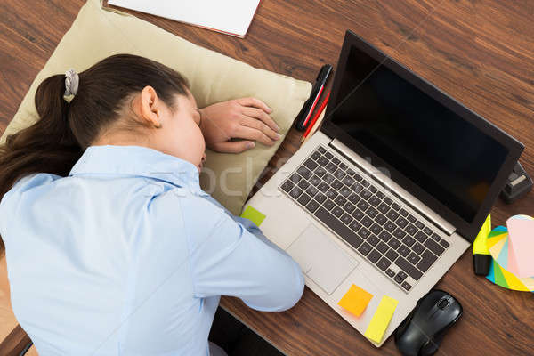 Businesswoman Sleeping With Cushion In Office Stock photo © AndreyPopov