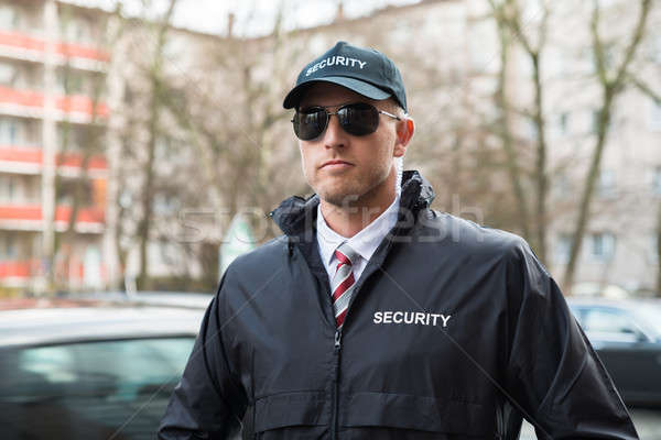 Retrato jóvenes guardia de seguridad negro uniforme Foto stock © AndreyPopov
