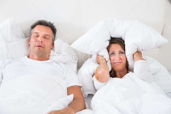 Angry Woman Trying To Sleep With Snoring Man Stock photo © AndreyPopov