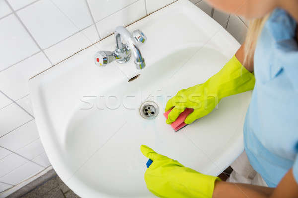 Woman Cleaning The Basin Of The Bathroom Stock photo © AndreyPopov